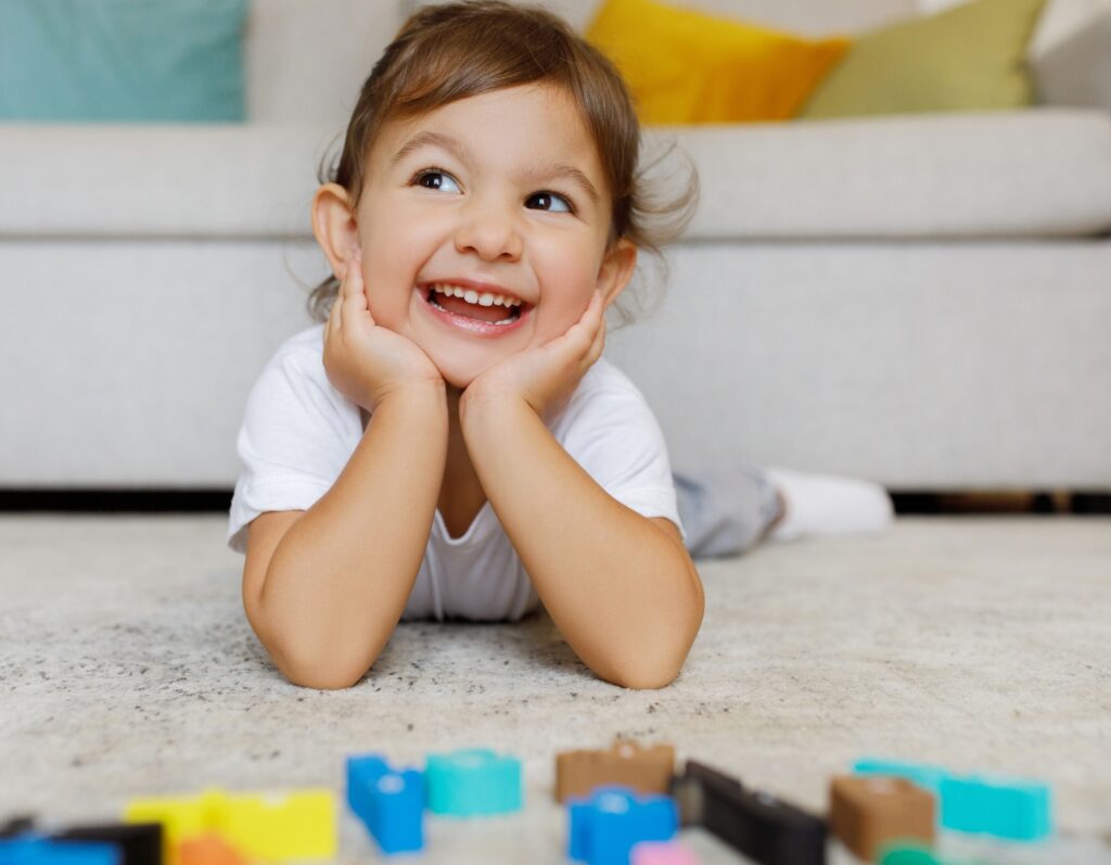 Dreamy Cute Toddler Girl Lying On Floor In Living Room Interior